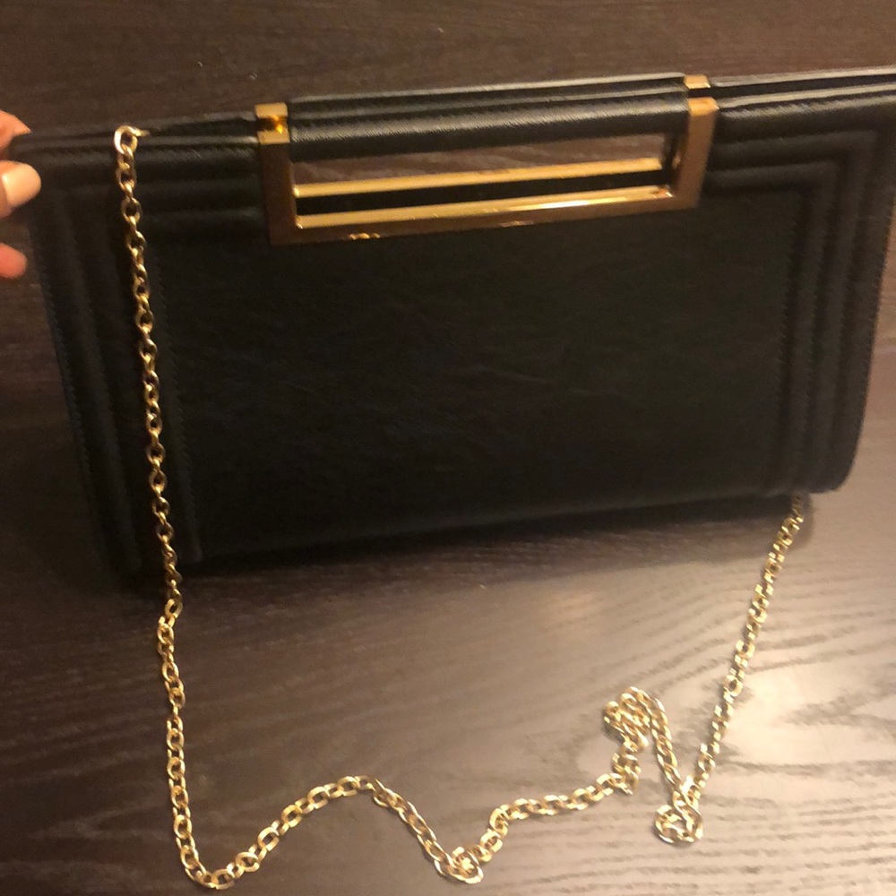 Black clutch with gold chain crossbody strap